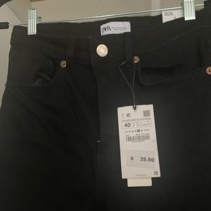 Never worn Zara black jeans with raw hem